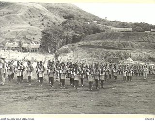 NADZAB, NEW GUINEA. 1944-09-26. MEMBERS OF THE 1ST NEW GUINEA INFANTRY BATTALION DURING AN INSPECTION BY VX13 LIEUTENANT GENERAL S.G. SAVIGE, CB, CBE, DSO, MC, ED, GOC NEW GUINEA FORCE AT CAMP ..