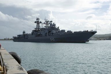 The Russian Federated Navy (RFN) ship MARSHAL SHAPOSHNIKOV (RFN 543), navigates through Apra Harbor, Guam (GU), as a US Navy (USN) Harbor Patrol Boat (HPB) secures the area. The SHAPOSHNIKOV is one of four RFN ships and two US Navy (USN) ships, which participated in the Passing Exercise (PASSEX) 2006, off the coast of Guam