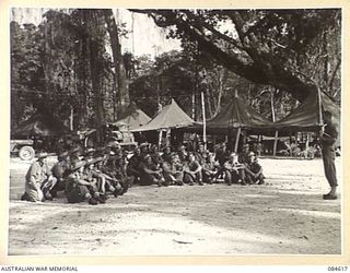 GREEN ISLAND, BOUGAINVILLE AREA, SOLOMON ISLANDS. 1944-12-21. SERGEANT G J ODGERS, AUSTRALIAN ARMY EDUCATION SERVICE ATTACHED HQ 23 INFANTRY BRIGADE, (1), LECTURING ON AUSTRALIAN FOREIGN POLICY TO ..
