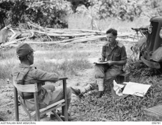 BUKA ISLAND, BOUGAINVILLE AREA, 1945-09-19. LIEUTENANT W.W. ROWED, OFFFICIAL WAR ARTIST, MAKING A PENCIL SKETCH OF JAPANESE NAVAL OFFICER. THE ARTIST ACCOMPANIED THE AUSTRALIAN SURRENDER PARTY FROM ..