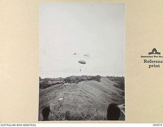 KIARIVU, NEW GUINEA, 1945-08-06. WITH THE OCCUPATION OF A FEATURE WHICH COMMANDED GROUND AROUND THE KIARIVU EMERGENCY LANDING GROUND, THE FIRST AIR DROP OF FOOD TO TROOPS OF 2/7 INFANTRY BATTALION ..