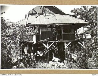 LOGAWENG, NEW GUINEA, 1943-10-25. THE LUTHERAN MISSION HOUSE, ONE OF THE MANY BUILDINGS OCCUPIED BY THE JAPANESE, DAMAGED AFTER IT HAD BEEN SUBJECTED TO HEAVY ALLIED BOMBING RAIDS