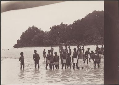 Islanders on the shore watching a ship's boat depart, Matema, Reef Islands, Swallow Group, Solomon Islands, 1906 / J.W. Beattie