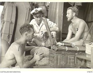 AT SEA. 1945-01-28. LEADING STOKER E.G. LEWELLEN (1) AND ABLE SEAMAN R. MELBOURNE (3) SUPERVISED BY SUB LIEUTENANT A. ILBURY (2) FITTING 2" MORTARS TO THE DECK OF THE ML802 OF THE ROYAL AUSTRALIAN ..