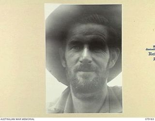 AITAPE AREA, NEW GUINEA. 1945-02-13. QX166 PRIVATE C. CHAMBERS, 2/2ND INFANTRY BATTALION, PROUDLY DISPLAYS HIS 40 DAY OLD BEARD BACK AT CAMP ON THE RETURN OF "JOCK FORCE". "JOCK FORCE" WAS A PATROL ..