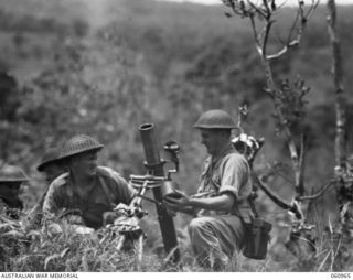 DONADABU AREA, NEW GUINEA. 1943-11-30. A MORTAR OF THE 2/10TH AUSTRALIAN INFANTRY BATTALION IN ACTION DURING A COMBINED EXERCISE WITH THE 2/4TH AUSTRALIAN FIELD REGIMENT. LEFT TO RIGHT: QX37765 ..