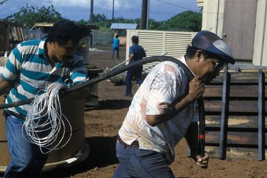 Local contractors work to get a US supplied generator on-line. The generator and other hardware were flown to Pago Pago by a 22nd Military Airlift Squadron C-5 Galaxy aircraft