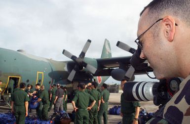 US Air Force (USAF) STAFF Sergeant (SSGT) Shane Cronin videos members of the Japanese Air Self Defense Force (JASDF) unloading cargo from a JASDF C-130 Hercules during Exercise COPE NORTH at Andersen Air Force Base (AFB), Guam