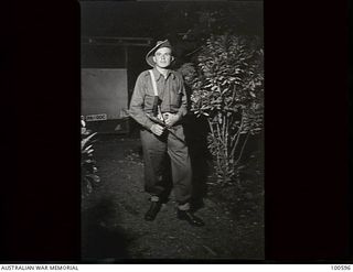 Lae, New Guinea. 1944-07-27. Portrait of Private W. V. Brown, 22 Platoon, F Company, 2/1st Guard Regiment standing guard at night outside the General Officer Commanding's building, HQ, New Guinea ..