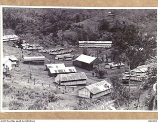 SOGERI, NEW GUINEA. 1943-11-20. VIEW OF PORTION OF THE SCHOOL OF SIGNALS, NEW GUINEA FORCE, WHICH HAS BEEN ALMOST ENTIRELY BUILT BY THE STAFF. THE COMMANDING OFFICER'S RESIDENCE CAN BE SEEN ON TOP ..