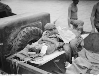 WAITAVALO, NEW BRITAIN. 1945-03-19. A WOUNDED SOLDIER PACIFIES A SHELL- SHOCKED FRIEND