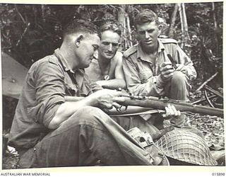 1943-10-01. NEW GUINEA. LAE. LEFT TO RIGHT. - SGT. J. GORDON, V.C. OF GIN GIN, W. AUSTRALIA, CAPT. F. HAYES OF BONDI N.S.W. AND PTE. A. SCOTT OF FITZROY, VICTORIA. (NEGATIVE BY MILITARY HISTORY ..