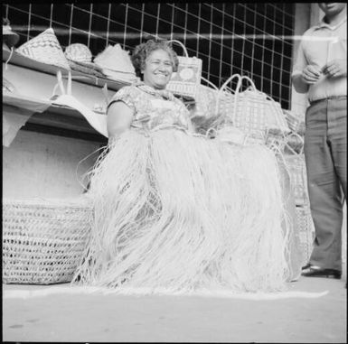 Female street vendor selling grass skirts, Fiji, 1966 / Michael Terry