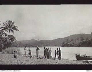 NEW GUINEA. 1943-07-28. THE WARIA RIVER AT MOROBE. LEFT TO RIGHT:- UNIDENTIFIED; VX89051 LIEUTENANT COLONEL J. P. DOWNEY MM, COMMANDING OFFICER, NO. 18 LINES OF COMMUNICATION (SIGNALS), CAPTAIN M. ..