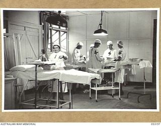 THE SEVENTEEN MILE, PORT MORESBY, NEW GUINEA. 1943-07-03. SCENE IN THE OPERATING THEATRE OF THE 2/9TH AUSTRALIAN GENERAL HOSPITAL. LEFT TO RIGHT:- VFX48615 SISTER M.O. HOLDING, NX76501 CAPTAIN N.J. ..