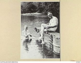 PORT MORESBY, PAPUA. 1942-07. RELAXING AFTER A LONG ROUTE MARCH, AUSTRALIAN TROOPS ENJOY THE FRESHNESS OF A NEW GUINEA MOUNTAIN STREAM