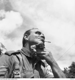 LALOKI VALLEY, NEW GUINEA. 1943-11-05. NX11590 SERGEANT J. W. MORRIS OF THE NEW GUINEA FORCE TRAINING SCHOOL (JUNGLE WING) WIPES THE PERSPIRATION AWAY AFTER A STIFF CLIMB DURING A PATROL IN THE ..