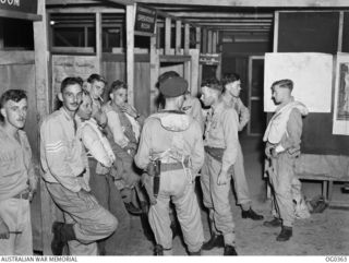 VIVIGANI, GOODENOUGH ISLAND, PAPUA. 1944-01-11. THESE RAAF AIRCREWS OF THE BEAUFORT BOMBER SQUADRONS RELAX IN THE OPERATIONS ROOM AFTER AN AIR ATTACK ON RABAUL