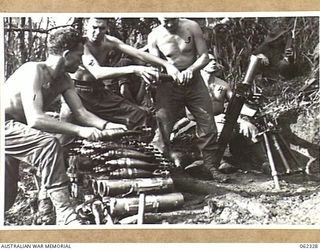 SHAGGY RIDGE, NEW GUINEA. 1943-12-27. MEMBERS OF A 3 INCH MORTAR CREW OF THE 2/16TH AUSTRALIAN INFANTRY BATTALION, 21ST AUSTRALIAN INFANTRY BRIGADE, IN ACTION BOMBARDING THE "PIMPLE" PRIOR TO THE ..