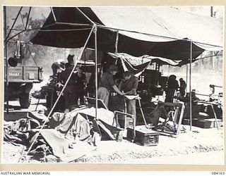 TOROKINA AREA, BOUGAINVILLE, SOLOMON ISLANDS. 1944-12-09. A PORTION OF THE GENERAL FITTING SHOP, 126 BRIGADE WORKSHOP AT A TEMPORARY CAMP SITE UNTIL CONDITIONS PERMIT TRANSFER TO AN ESTABLISHED ..