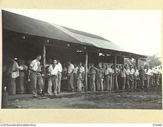 LAE. NEW GUINEA. 1944-07-14. PATIENTS OF THE 2/7TH AUSTRALIAN GENERAL HOSPITAL LINED UP IN THE QUEUE DURING A UNIT MESS PARADE