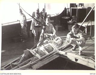 BOUGAINVILLE. 1945-09-21. JAPANESE WOUNDED BEING BROUGHT ABOARD THE DEBORAH IN A "STOKES LITTER" DURING THEIR EVACUATION FROM NUMA NUMA TO TOROKINA. THE EVACUATION FOLLOWING THE ARRIVAL AT NUMA ..