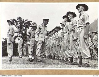 17 MILE, PORT MORESBY AREA, NEW GUINEA. 1943-12-24. VX247 BRIGADIER C. A. STINSON, DEPUTY DIRECTOR OF ORDNANCE SERVICES, HEADQUARTERS, NEW GUINEA FORCE (1), INSPECTS THE TROOPS OF THE 10TH ..