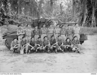 Group portrait of personnel of the Administrative Troop, B Squadron, 2/4th Armoured regiment. Left to right, back row: NX104119 Trooper (Tpr) W D Scott of Young, NSW; VX90833 Tpr T A Brown of ..