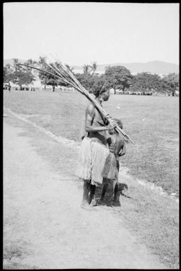 Child and a woman holding a bow and arrow, Papua, ca. 1923 / Sarah Chinnery