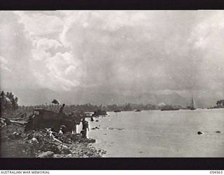 MILNE BAY, NEW GUINEA, 1943-07-11. TROOPS OF THE 4TH AUSTRALIAN FIELD COMPANY, ROYAL AUSTRALIAN ENGINEERS, DUMPING FILLING DURING THE CONSTRUCTION OF A 960 FEET "T" JETTY