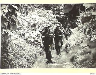 WEBER'S CREEK, MALALAMAI, NEW GUINEA, 1944-02-09. MEMBERS OF "B" COMPANY, 30TH INFANTRY BATTALION ON THE TRAIL BETWEEN WEBER POINT AND MALALAMAI. THEY HAVE BEEN ADVANCING FROM ROINJI (2) OVER MUDDY ..