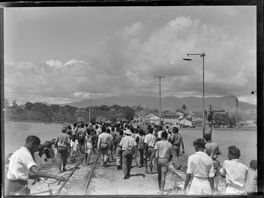 Crowd of people walking along the wharf, Suva, Fiji