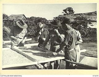 HIGITURA, NEW GUINEA. 1944-04-27. NX191031 LIEUTENANT-COLONEL A.A. CONLON, DIRECTORATE OF ARMY RESEARCH (1), WITH PX168 CAPTAIN J. B. MCKENNA, ASSISTANT DISTRICT OFFICER MAMBARE, AUSTRALIAN NEW ..