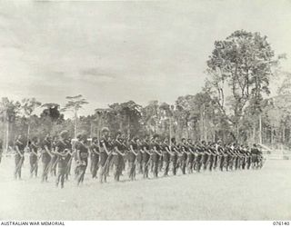 LAE, NEW GUINEA. 1944-09-16. MEMBERS OF THE ROYAL PAPUAN CONSTABULARY ON PARADE FOR THE PRESENTATION OF THE BRITISH EMPIRE MEDAL, (CIVIL DIVISION), TO GOMERI. THE INVESTMENT WAS MADE BY ..