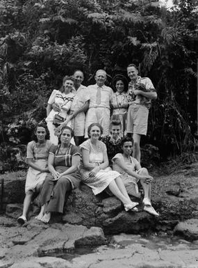 [Group portrait of Tudor Collins, two men and seven women]