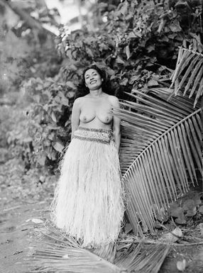 [Full-length portrait of a bare-breasted Polynesian woman wearing a titi (grass skirt)]