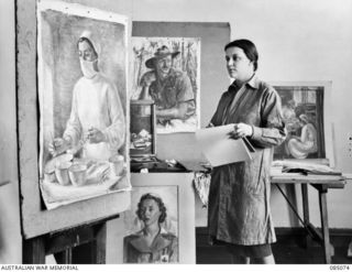 MELBOURNE, VIC. 1945-01-09. CAPTAIN NORA HEYSEN, OFFICIAL WAR ARTIST, MILITARY HISTORY SECTION, IN HER STUDIO AT 138 FLINDERS STREET COMPLETING PAINTINGS WHICH WERE COMMENCED IN NEW GUINEA