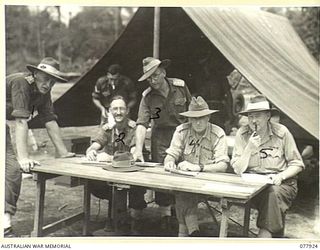 TOROKINA, BOUGAINVILLE ISLAND. 1945-01-01. OFFICERS AT THE BROADCASTING POINT DURING THE ATHLETIC MEETING ORGANISED BY HEADQUARTERS, 3RD DIVISION AND HELD ON THE SPORTS ARENA MEMORIAL PARK. ..