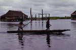 Two boys on canoe, at Kambaram village where all the houses are built on piles over the water, Sepik area, [Papua New Guinea, 1969?]