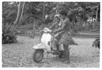 Young man and woman with motor scooter