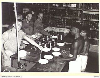 LAE, NEW GUINEA. 1945-11-25. THE MODERN KITCHEN EQUIPMENT INSTALLED AT THE AUSTRALIAN ARMY CANTEENS SERVICE OFFICERS' CLUB. AUSTRALIAN MILITARY FORCES PERSONNEL CARRY OUT ALL THE COOKING AND SERVE ..