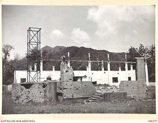 RABAUL, NEW BRITAIN, 1945-09-10. ALL BUILDINGS AND INSTALLATIONS AT RABAUL WERE DESTROYED DURING ALLIED AIR ATTACKS. THIS PHOTOGRAPH SHOWS THE WRECKAGE OF A LARGE BURNS PHILP STORE. TROOPS OF 4 ..