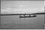 Canoes: men on a small outrigger canoe, pot on platform (l)