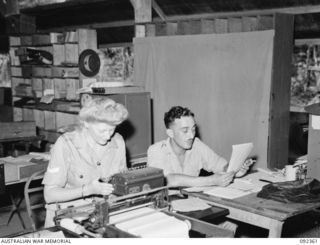 LAE, NEW GUINEA, 1945-05-23. CORPORAL. D. COASE, AWAS (1) AND PRIVATE W. MAAS (2), WORKING AT NO 3 SUB DEPOT, 4 ADVANCED ORDNANCE DEPOT. AWAS PERSONNEL ARE AT LAE TO RELEASE HQ FIRST ARMY MEN FOR ..