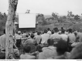 NEW GUINEA. 1944-01-08. AN APPRECIATIVE AUDIENCE WATCHING A FILM AT AN OUTDOOR PICTURE THEATRE AT A RAAF STATION IN THE AREA