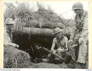 1943-01-08. AMERICAN AND AUSTRALIAN WAR CORRESPONDENTS AT A JAPANESE DUGOUT INSPECT A LIGHT JAPANESE ARTILLERY PIECE WHICH HAS BEEN BLASTED FROM ITS MOUNTING BY AN AUSTRALIAN MANNED TANK, WHICH ..