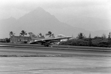 An Air Force F-16A Fighting Falcon takes off. The F-16A is from the 428th Tactical Fighter Squadron located at Nellis Air Force Base, Nevada, and is here to fly with Marine F-4 Phantom aircraft in support of Hawaii-based Army units. The event is a Joint Chiefs of STAFF exercise, which will last for one month (2 Oct to 2 Nov 1981)