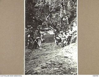 DUMPU, NEW GUINEA, 1943-10-08. TROOPS OF NO. 3 SECTION, 2/6TH AUSTRALIAN FIELD COMPANY, ROYAL AUSTRALIAN ENGINEERS, CONSTRUCTING A CAUSEWAY AND BRIDGE OVER A STEEP SIDED CREEK IN THE RAMU VALLEY. ..