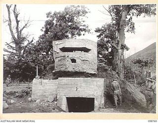 RABAUL, NEW BRITAIN. 1945-11-10. JAPANESE TROOPS DEMOLISHING A TYPICAL JAPANESE PILLBOX SITUATED NEAR THE GOVERNMENT WHARF