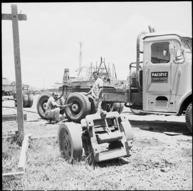 Two Pacific Lumber Company employees changing a truck tyre, Fiji, November 1969 / Michael Terry